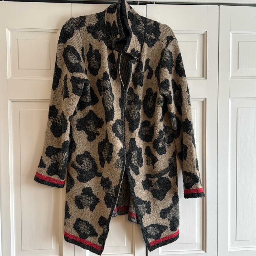 Almost New Leopard Open Cardigan with patch pockets and red trim.